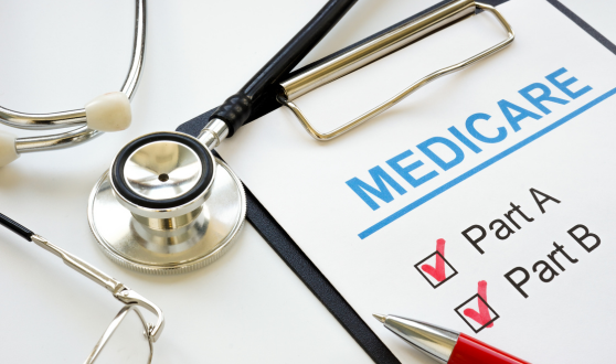 Stethoscope and clipboard with a paper on it reading Medicare and check boxes next to Part A and Part B, both checked