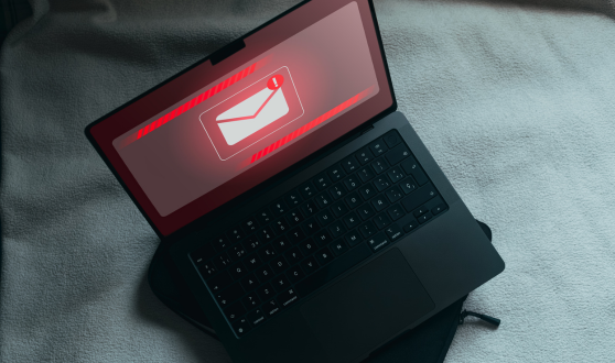 Computer with email logo with a red exclamation point