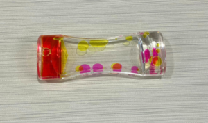 Cylinder filled with various colors of floating liquid