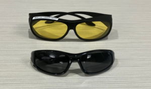 Two sets of sunglasses, one dark and one amber