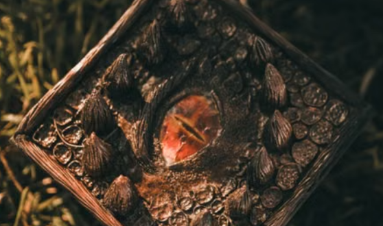 Sculpted square with a dragon eye in the center and scales and spines around it