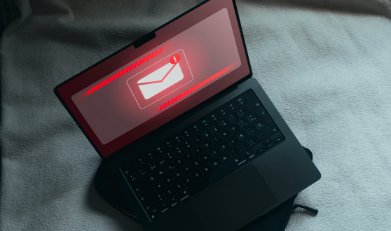Laptop with screens showing red notification email